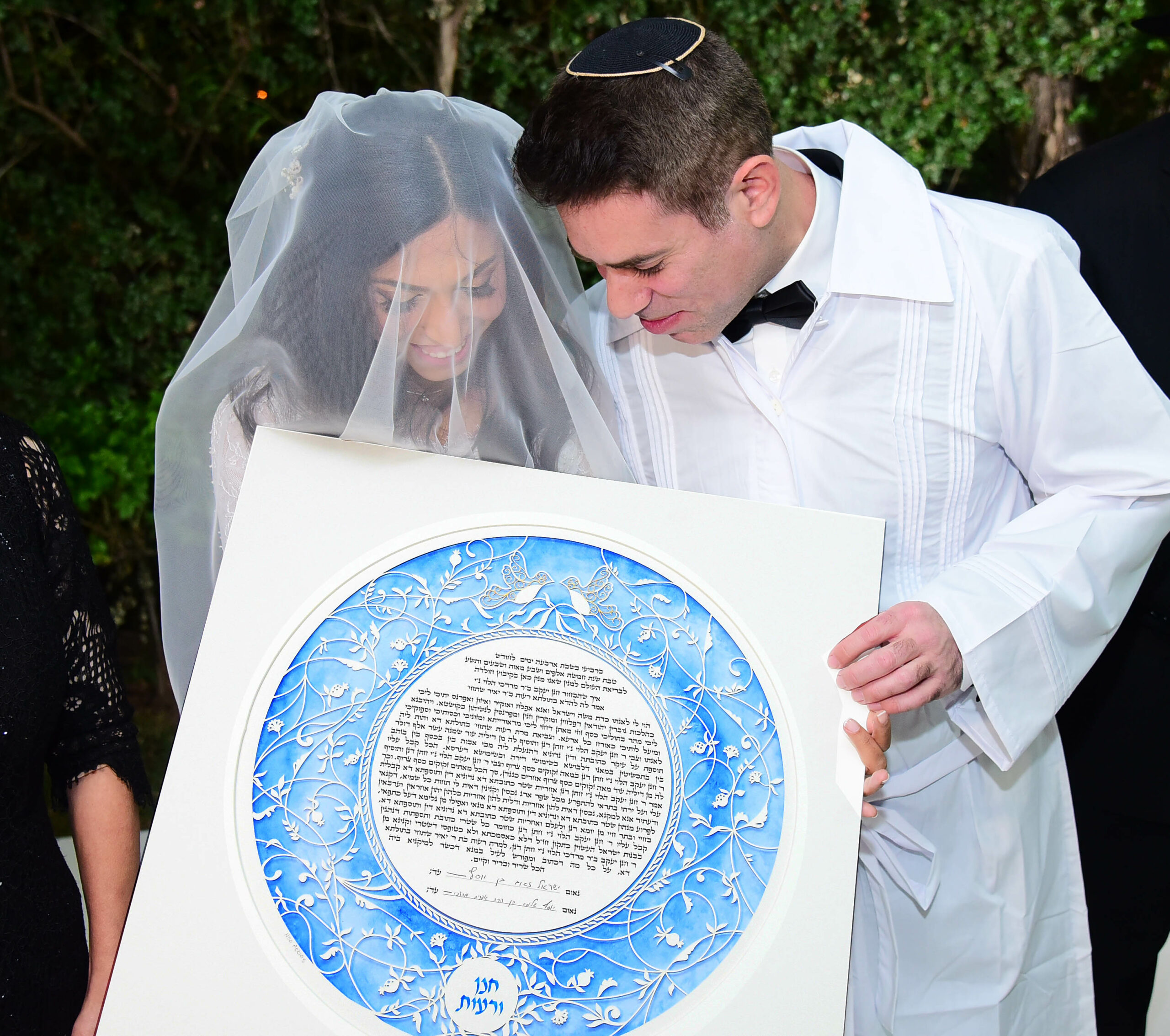 A couple deeply engrossed in choosing their perfect ketubah